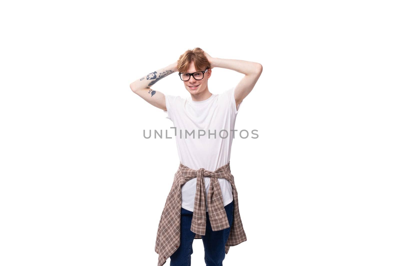 close-up of a slender young caucasian man with red hair in a white t-shirt on a white background by TRMK