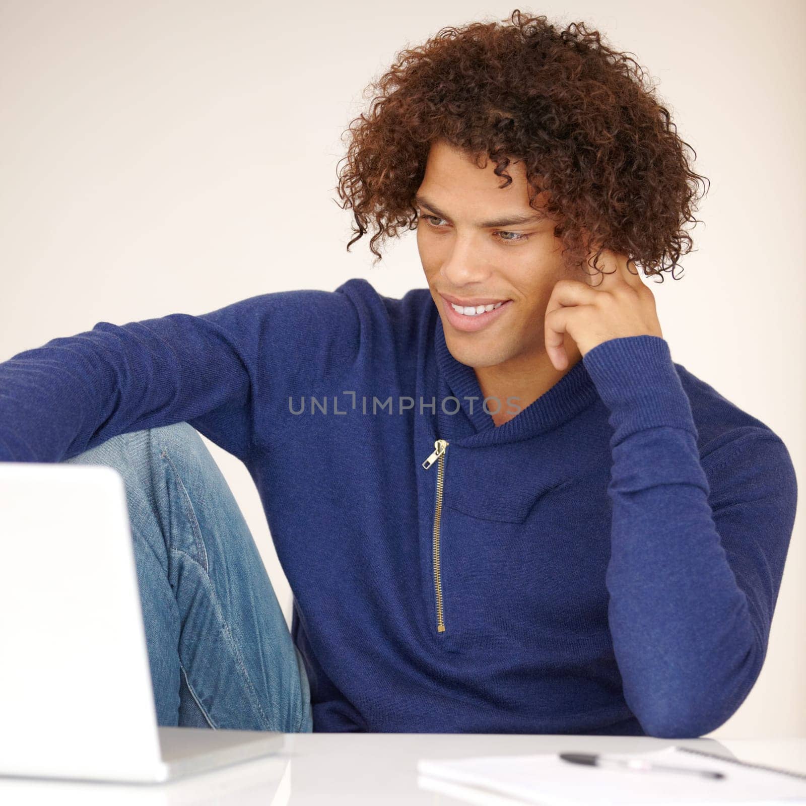 Laptop, student and man online in studio for research, internet and reading news on website. Happy, university and person on computer for connection, elearning and education on white background.