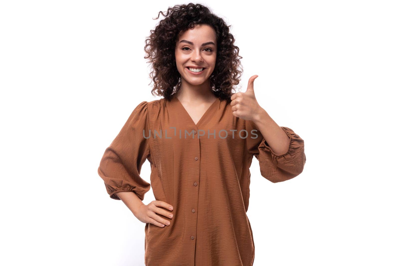 young pretty businesswoman dressed in a brown blouse on a white background with copy space by TRMK