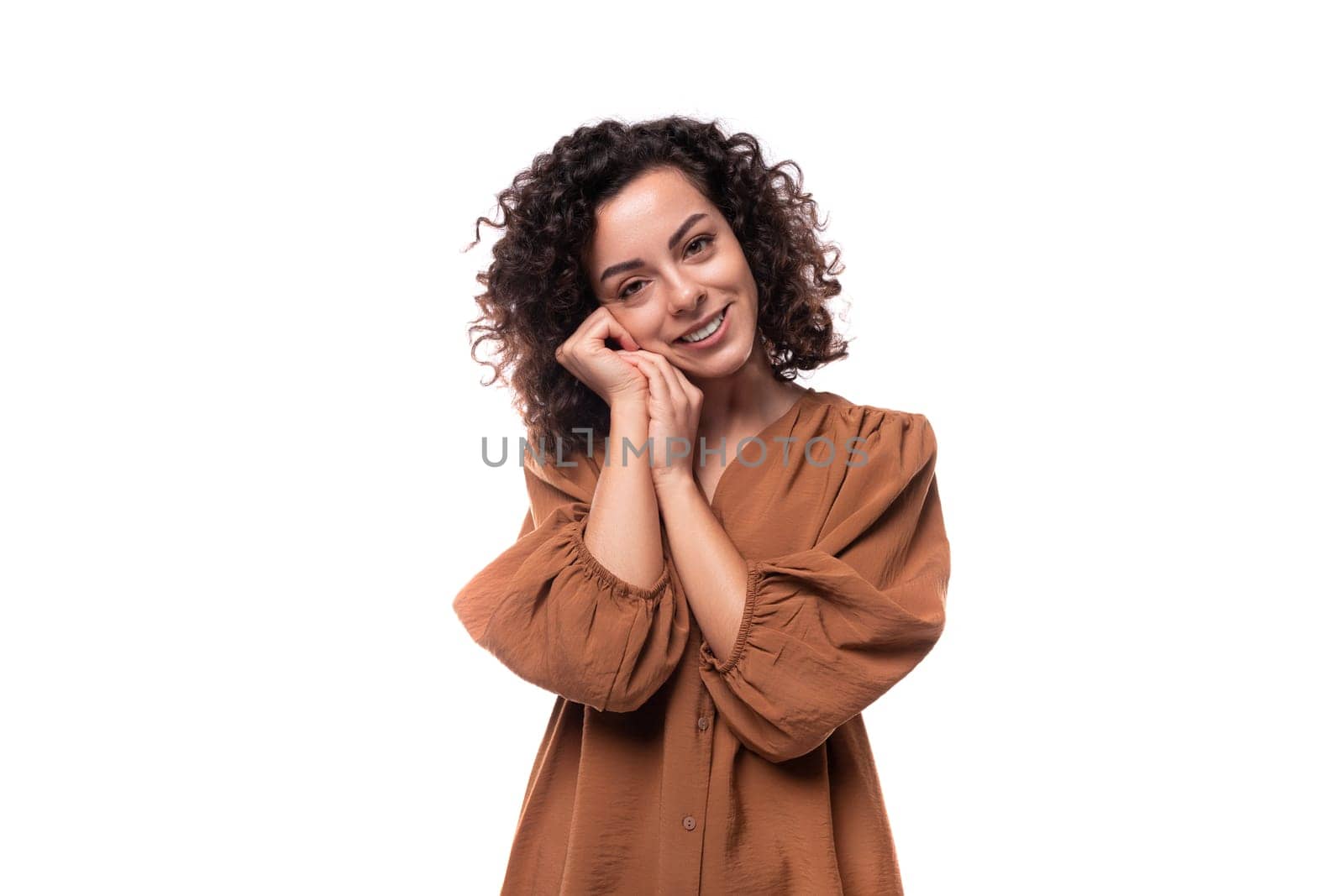 young active pretty caucasian woman with curly black hair dressed in a brown shirt by TRMK