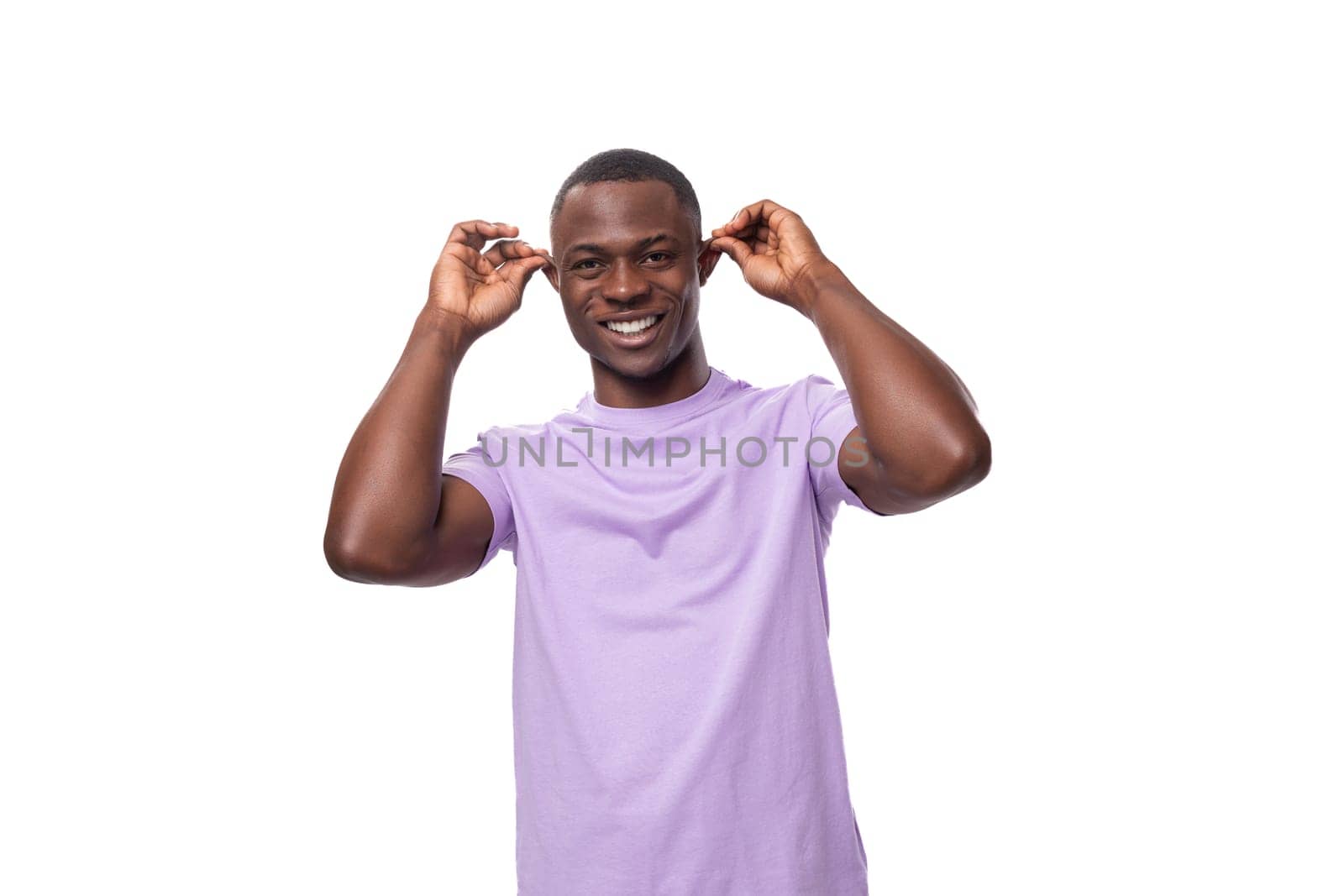 young authentic american guy dressed in a light lilac t-shirt on a white background.