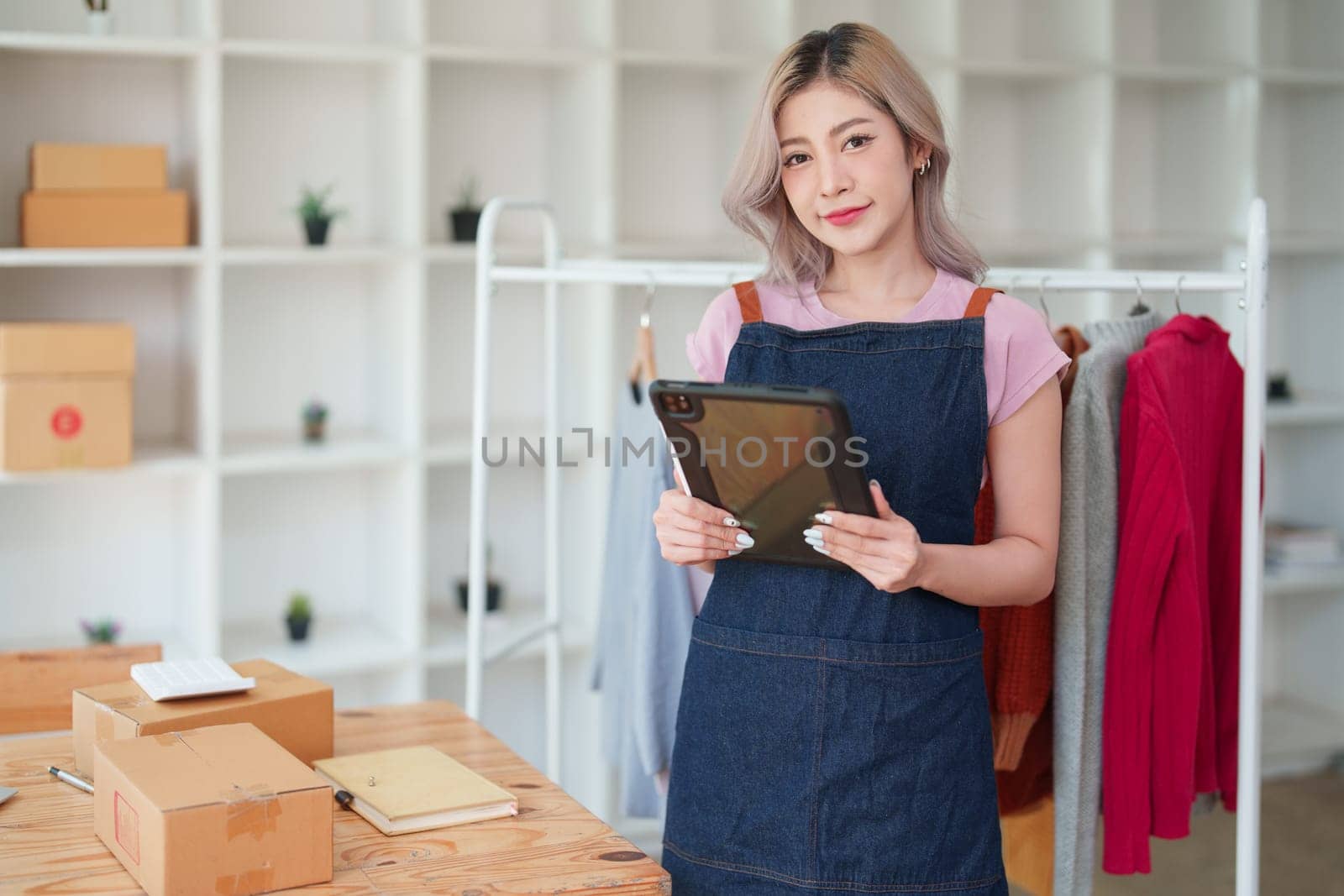 Portrait Of Asian Female Owner Of Fashion Store Clothing Store successful happy smile at small business, sme or ecommerce concepts by Manastrong