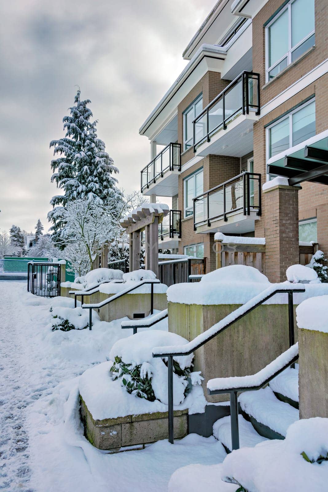 Low-rise residential building in snow on winter season in Vancouver, Canada.