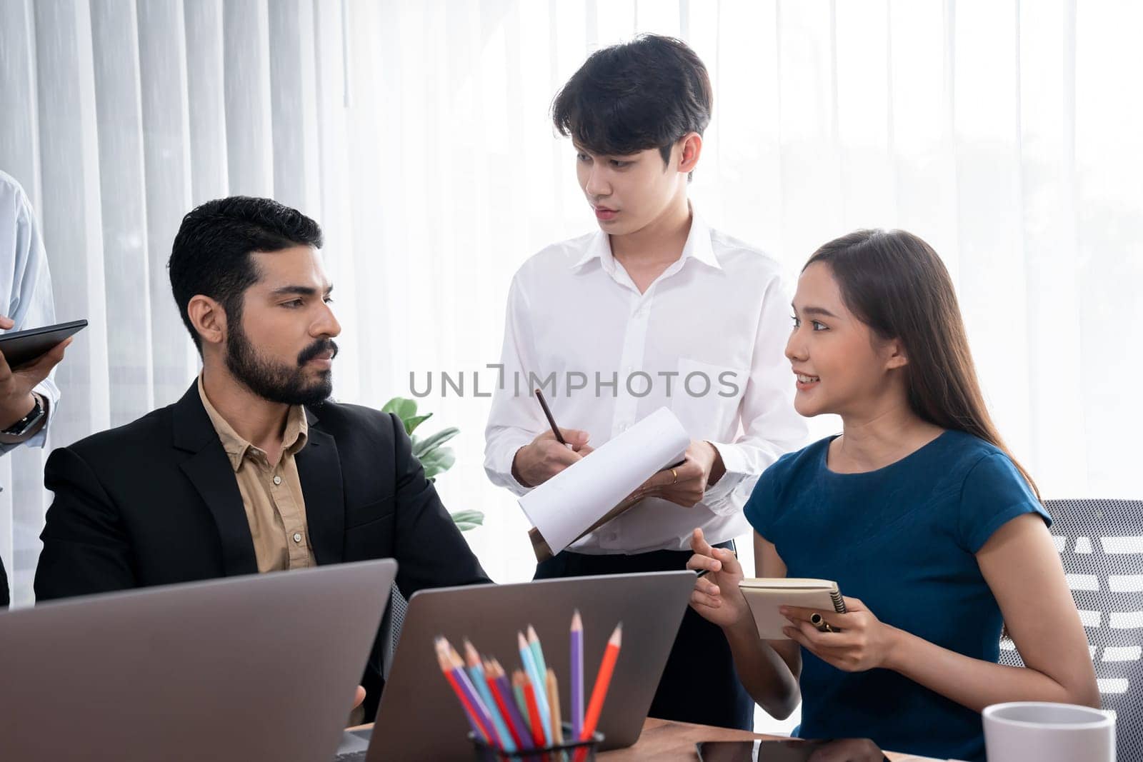 Asian office workers in office discussing and working together. Concord by biancoblue