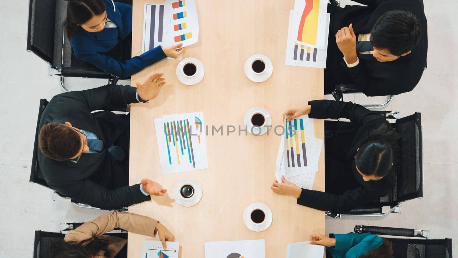 Business people group meeting shot from top view in office . Profession businesswomen, businessmen and office workers working in team conference with project planning document on meeting table . Jivy