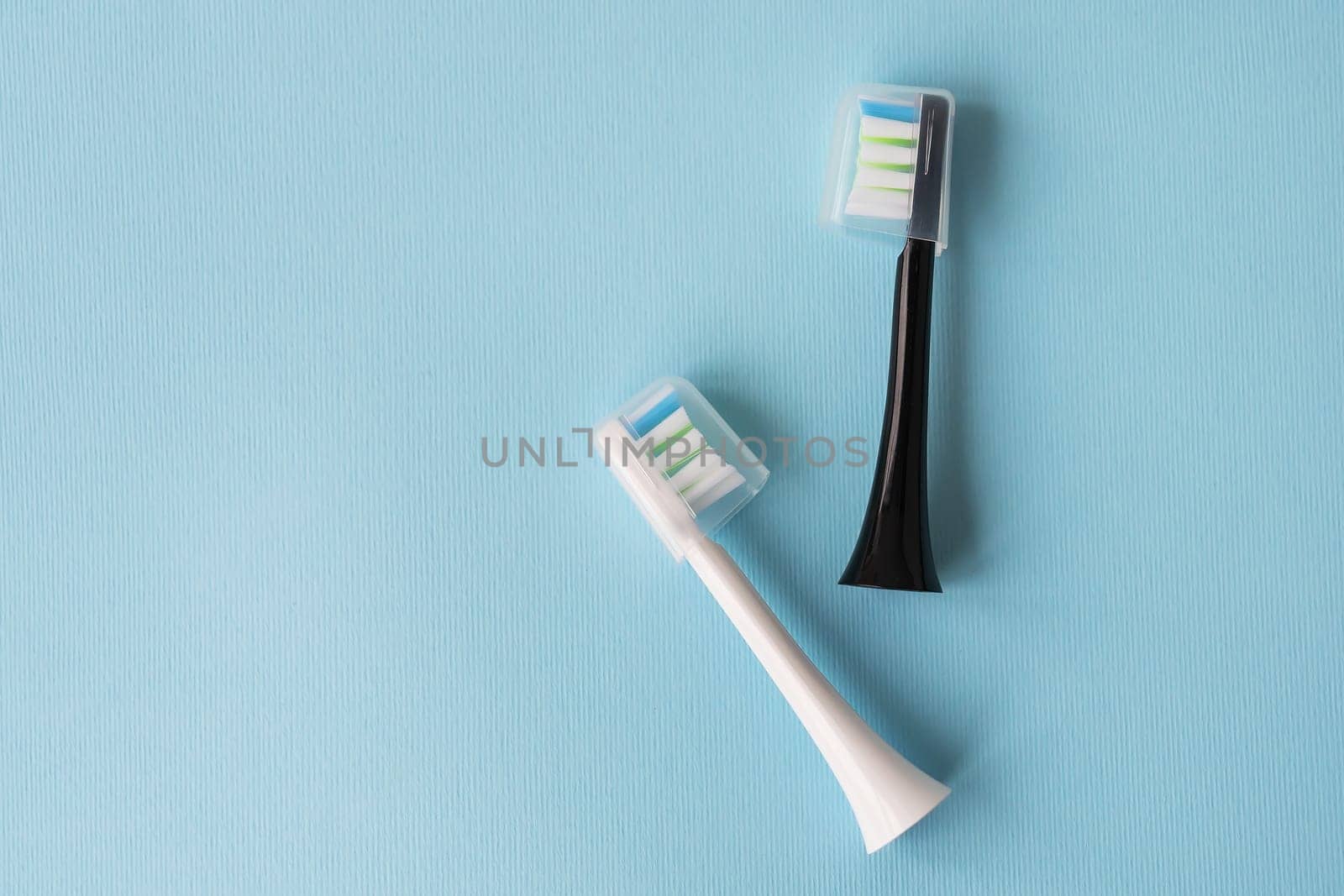 Modern electric toothbrush on a blue background. Hygiene concept for daily oral care