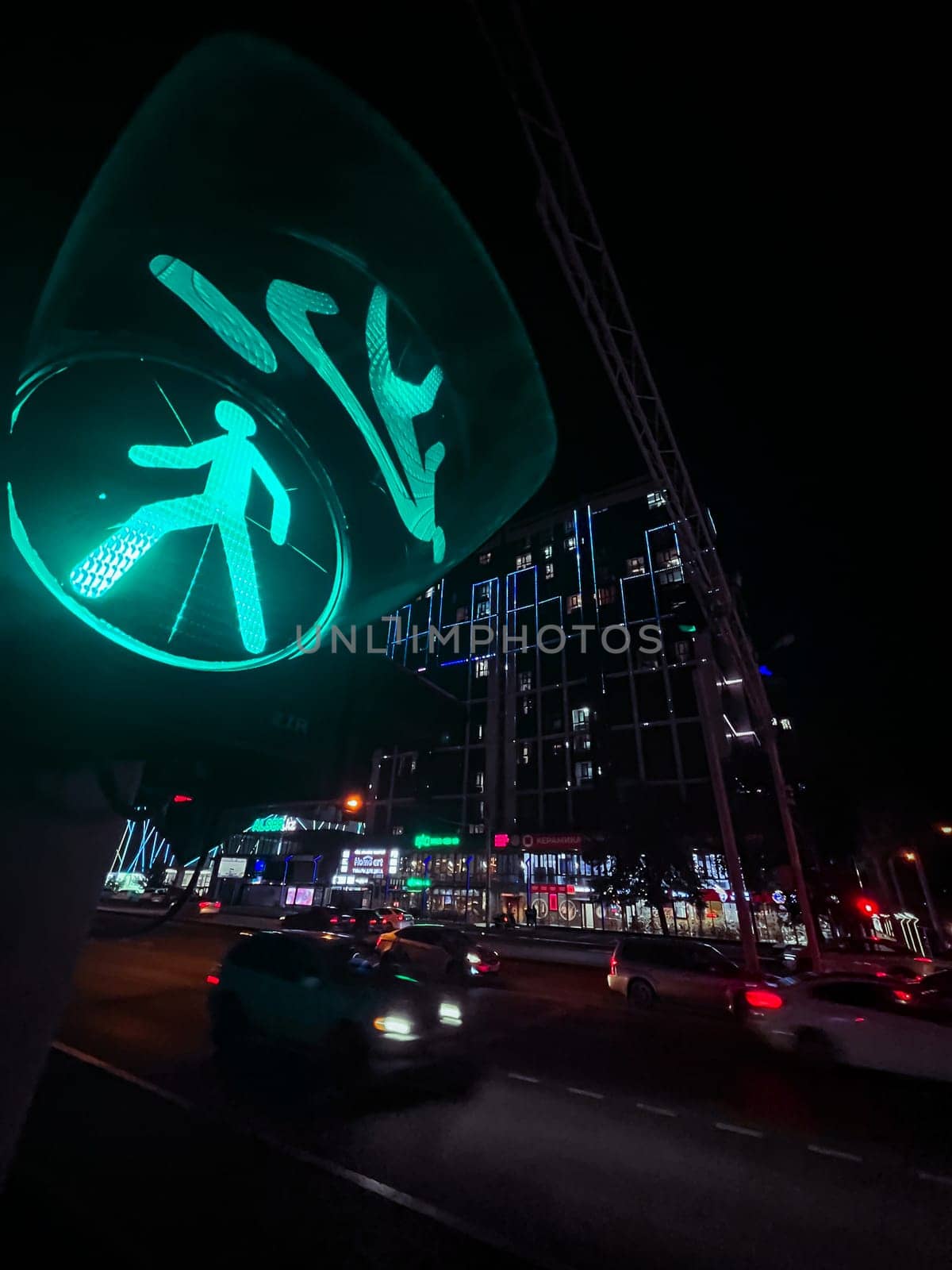 green traffic light at night. street photography at a wide angle.