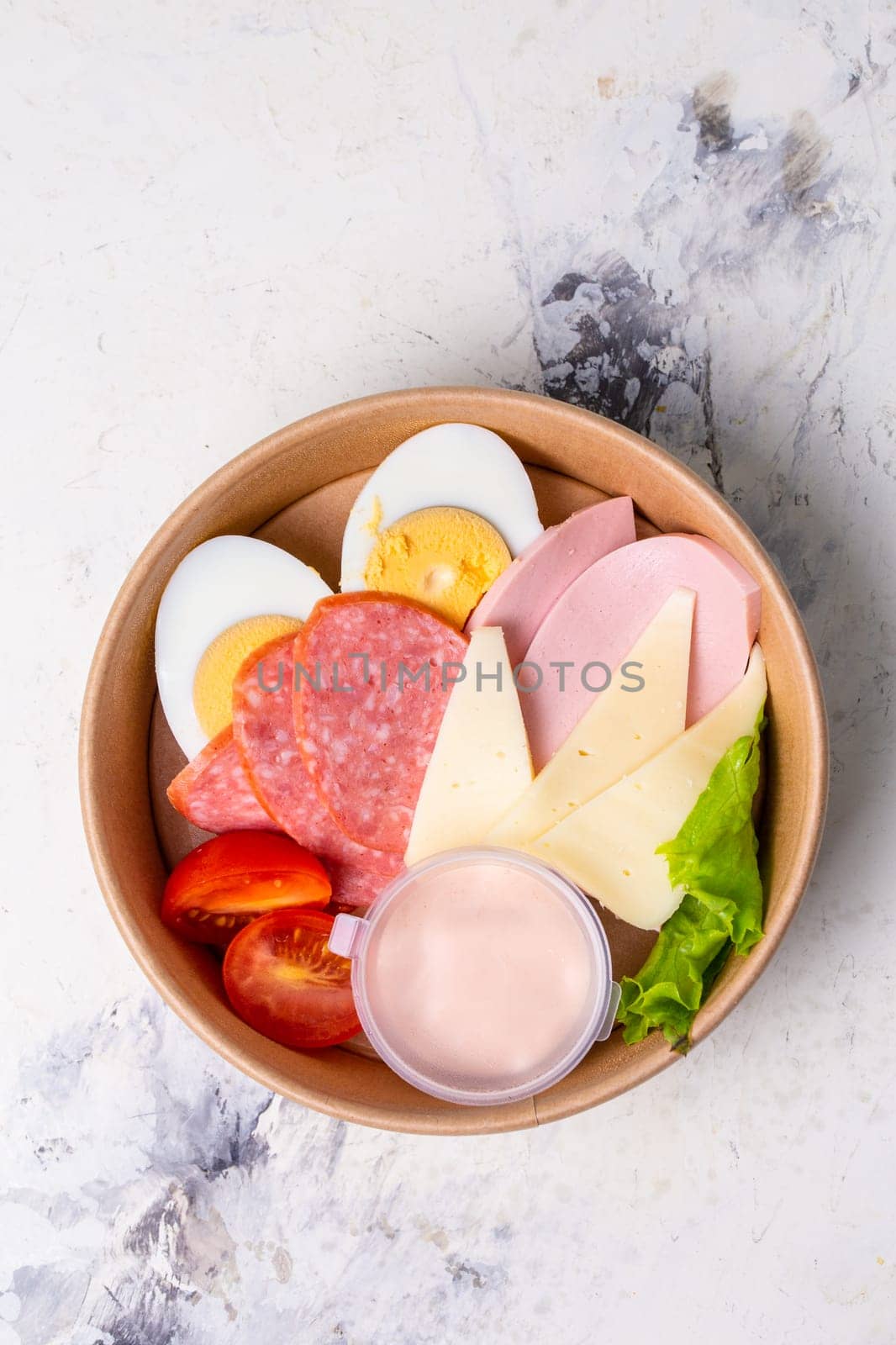 top view of a craft breakfast plate, sausage, tomato, egg and cheese