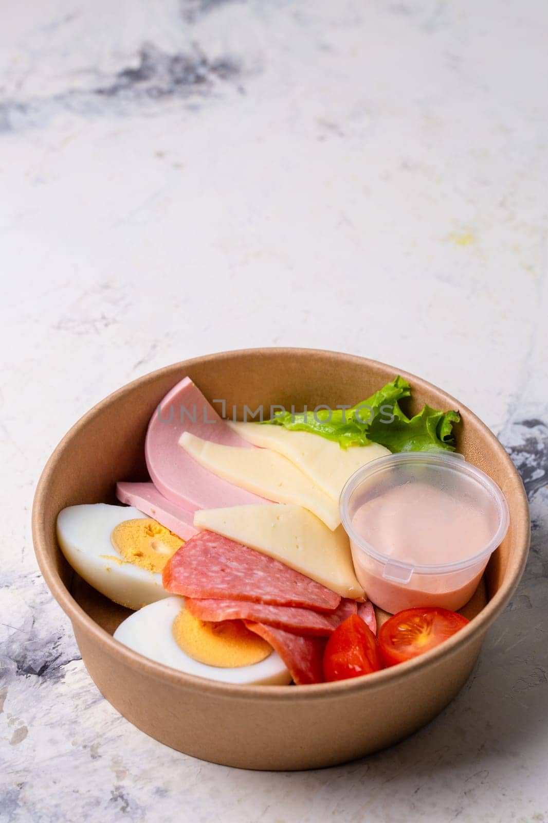 top view of a craft breakfast plate, sausage, tomato, egg and cheese