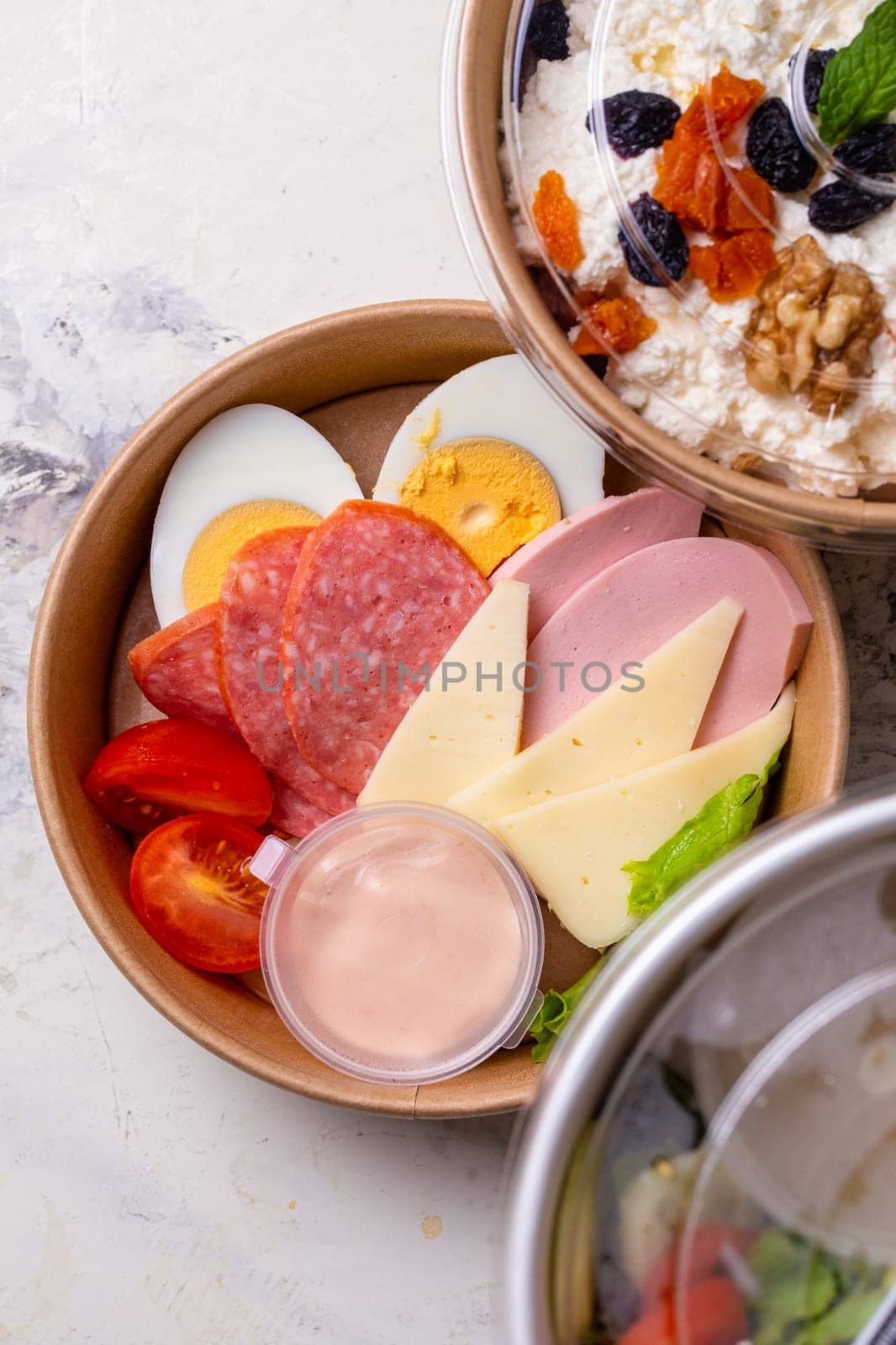 top view of a craft plate with breakfast close-up. Sausage, tomato, egg and cheese. by Pukhovskiy