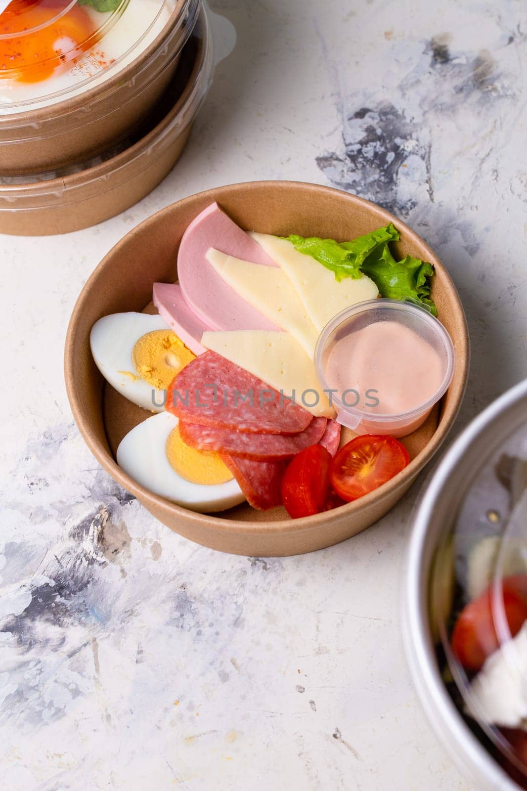 top view of a craft breakfast plate, sausage, tomato, egg and cheese