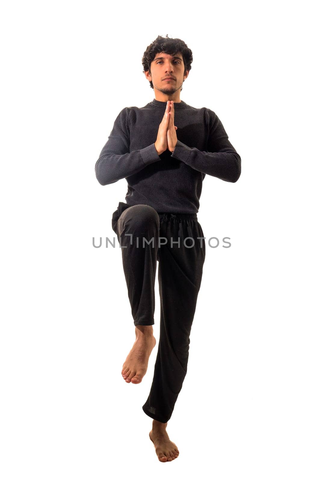 A man is doing a yoga pose on a white background