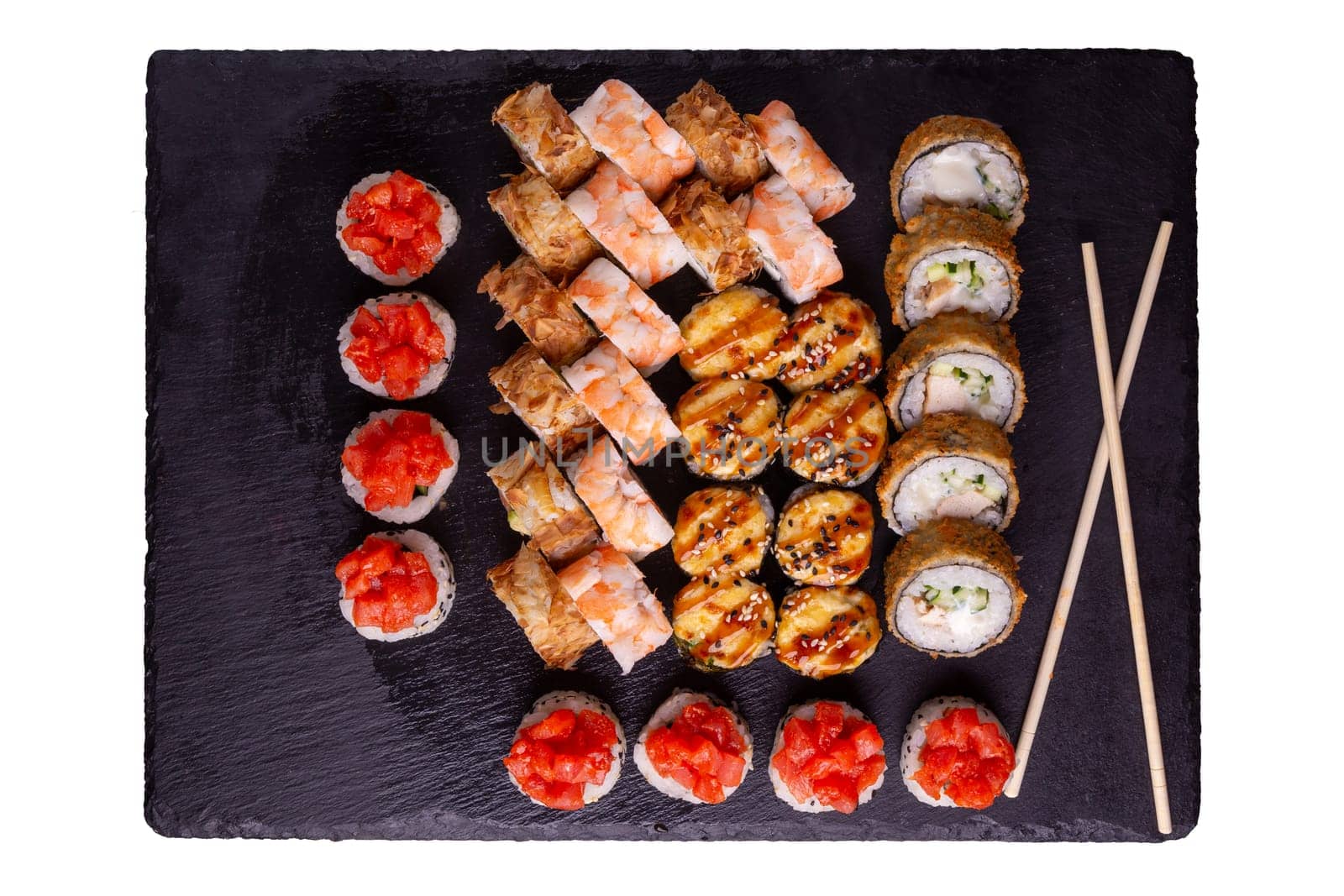 Sushi set on slate plate isolated on white background. 5 types of rolls in one set. Top view.