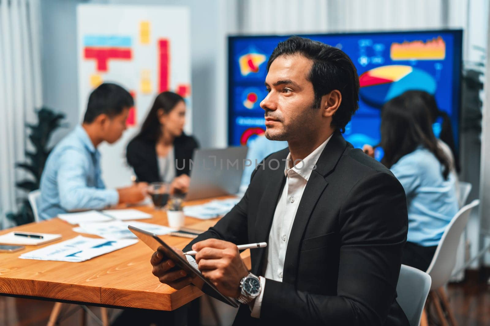 Portrait of businessman or analyst looking at camera in meeting. Meticulous by biancoblue