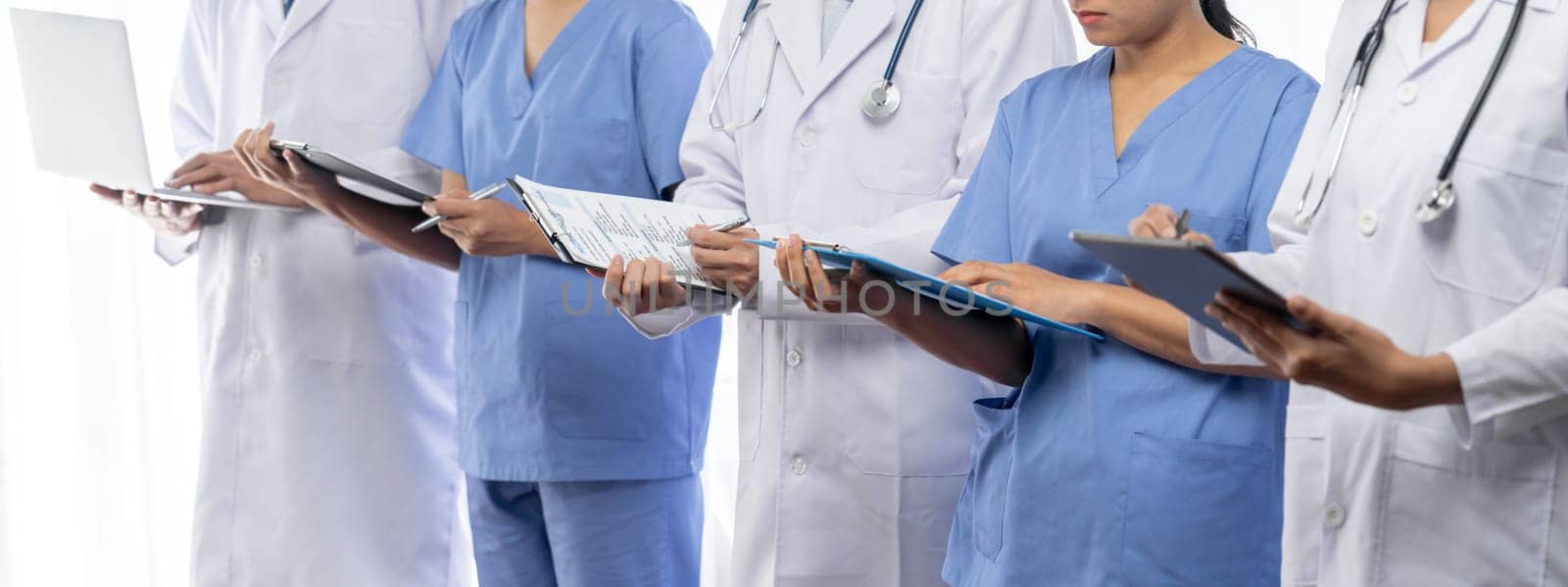 Confident medical staff team with doctor nurse and healthcare specialist professions people in hospital or clinic office. Medical and healthcare community in panoramic banner. Neoteric