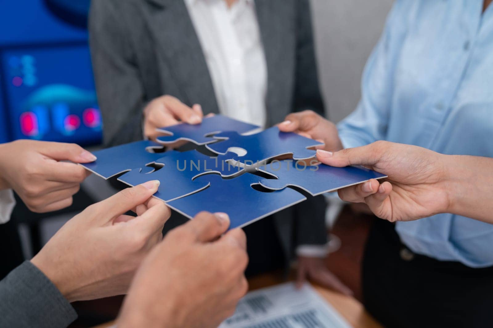 Corporate officer workers connecting puzzle pieces on table. Concord by biancoblue