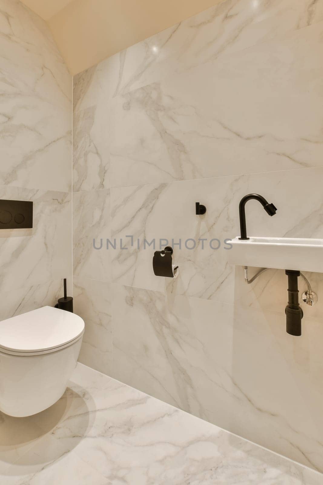 a white bathroom with a toilet and a sink by casamedia