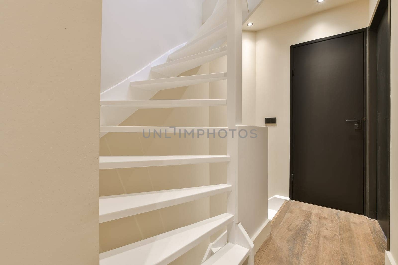 a set of stairs in a hallway with a door by casamedia