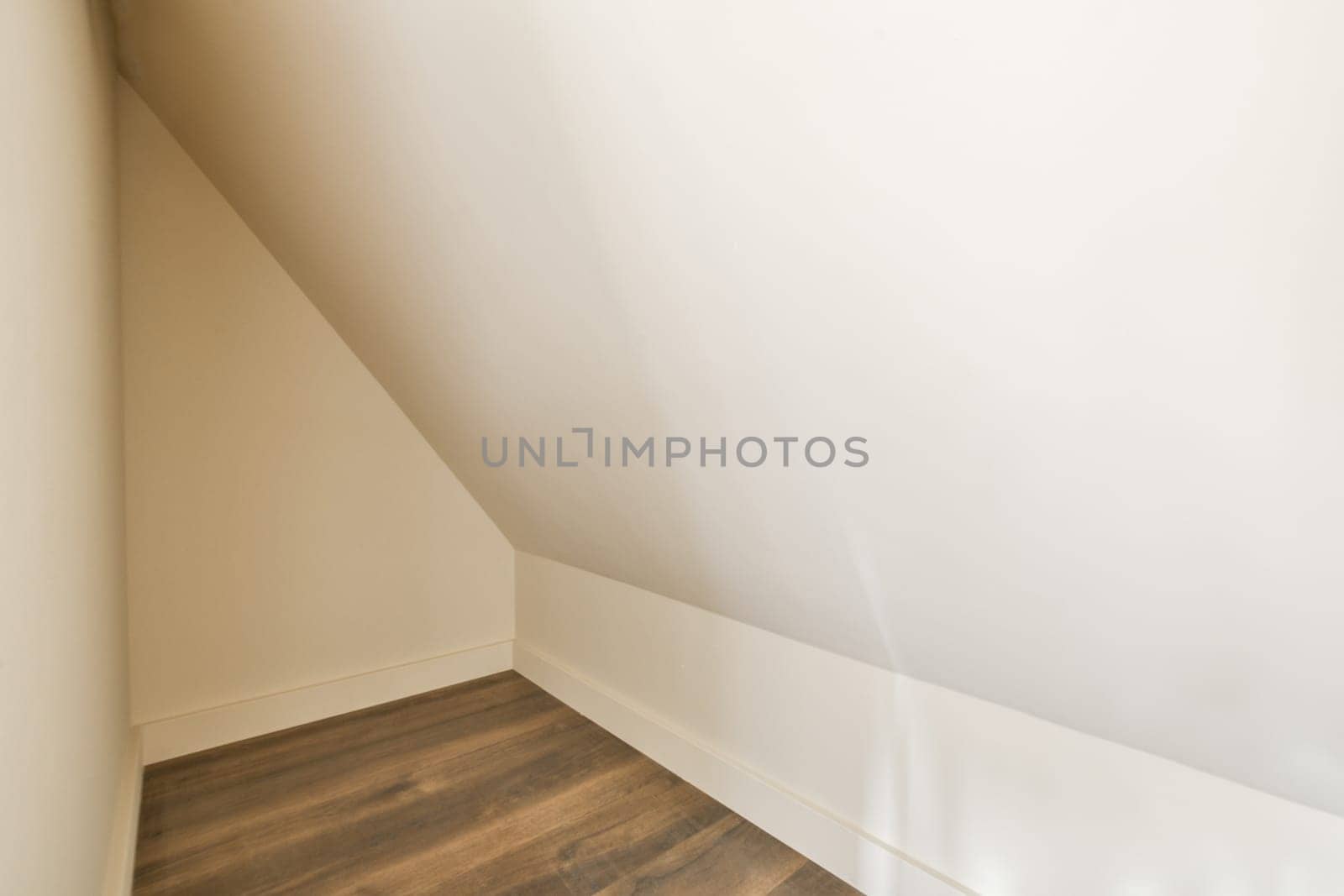 an empty room with wooden floor and white walls by casamedia