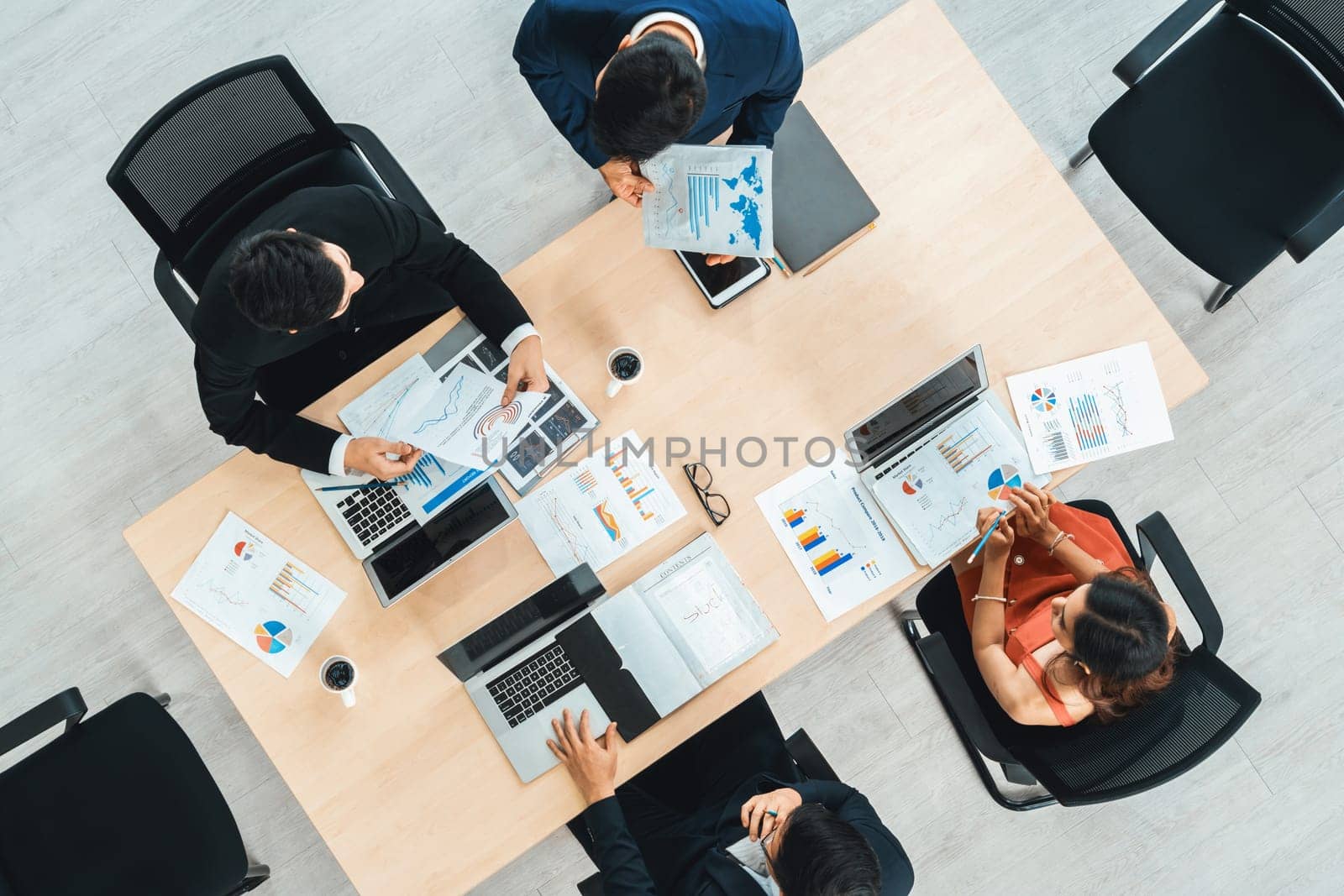 Business people group meeting shot from top view in office . Profession businesswomen, businessmen and office workers working in team conference with project planning document on meeting table . Jivy