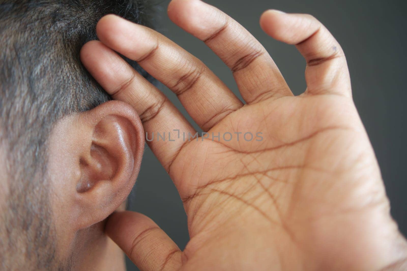 young man having ear pain touching his painful ear
