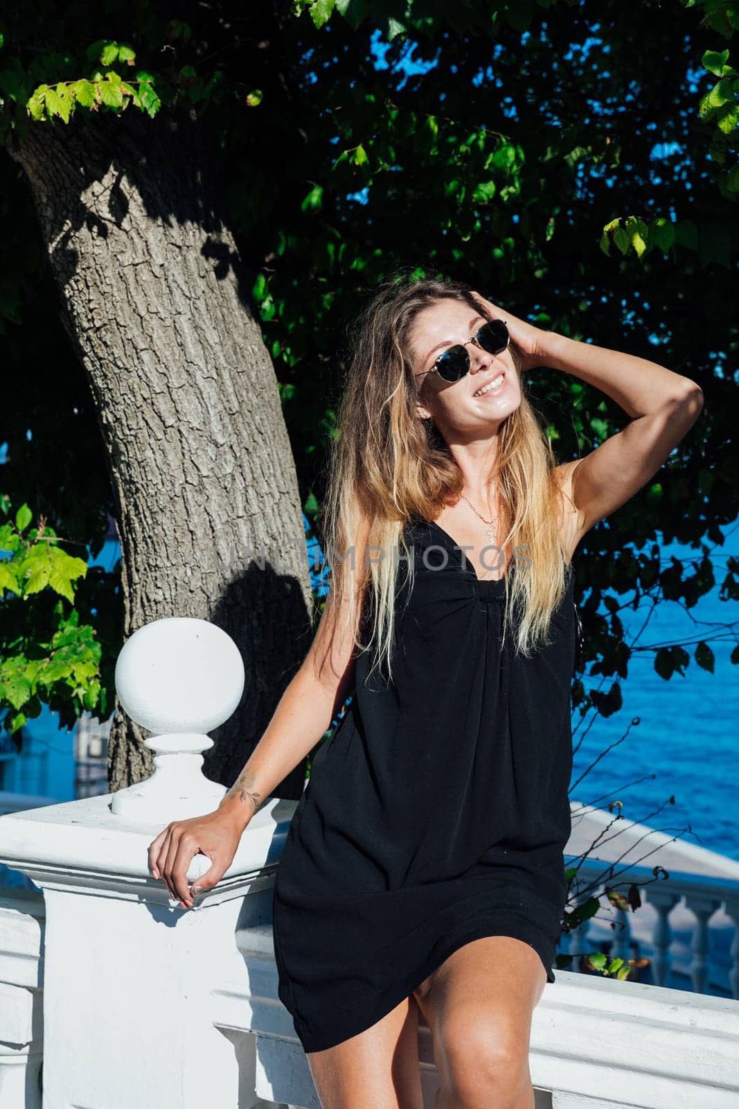 Beautiful slender woman in black summer dress by Simakov