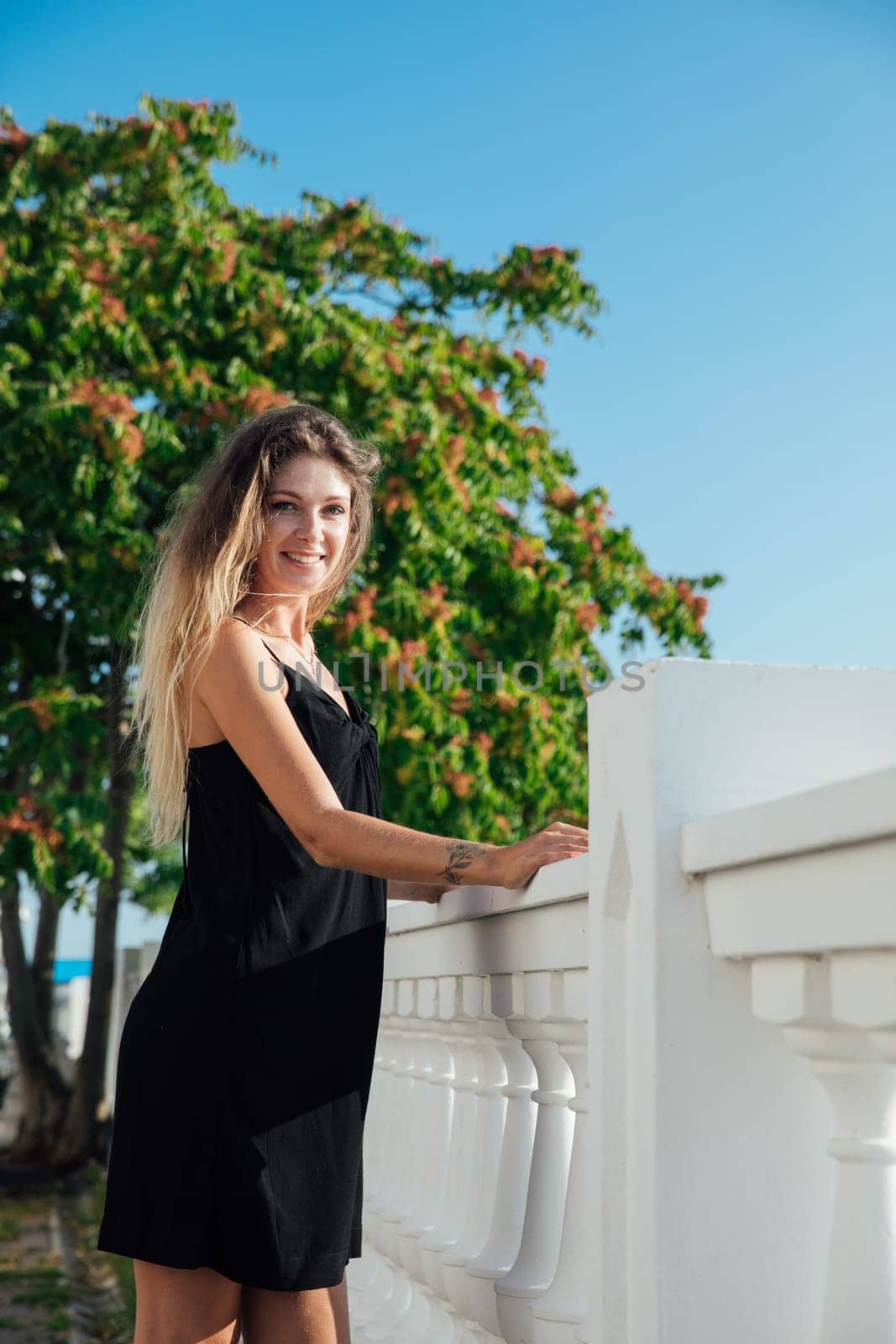 Beautiful woman in black summer dress