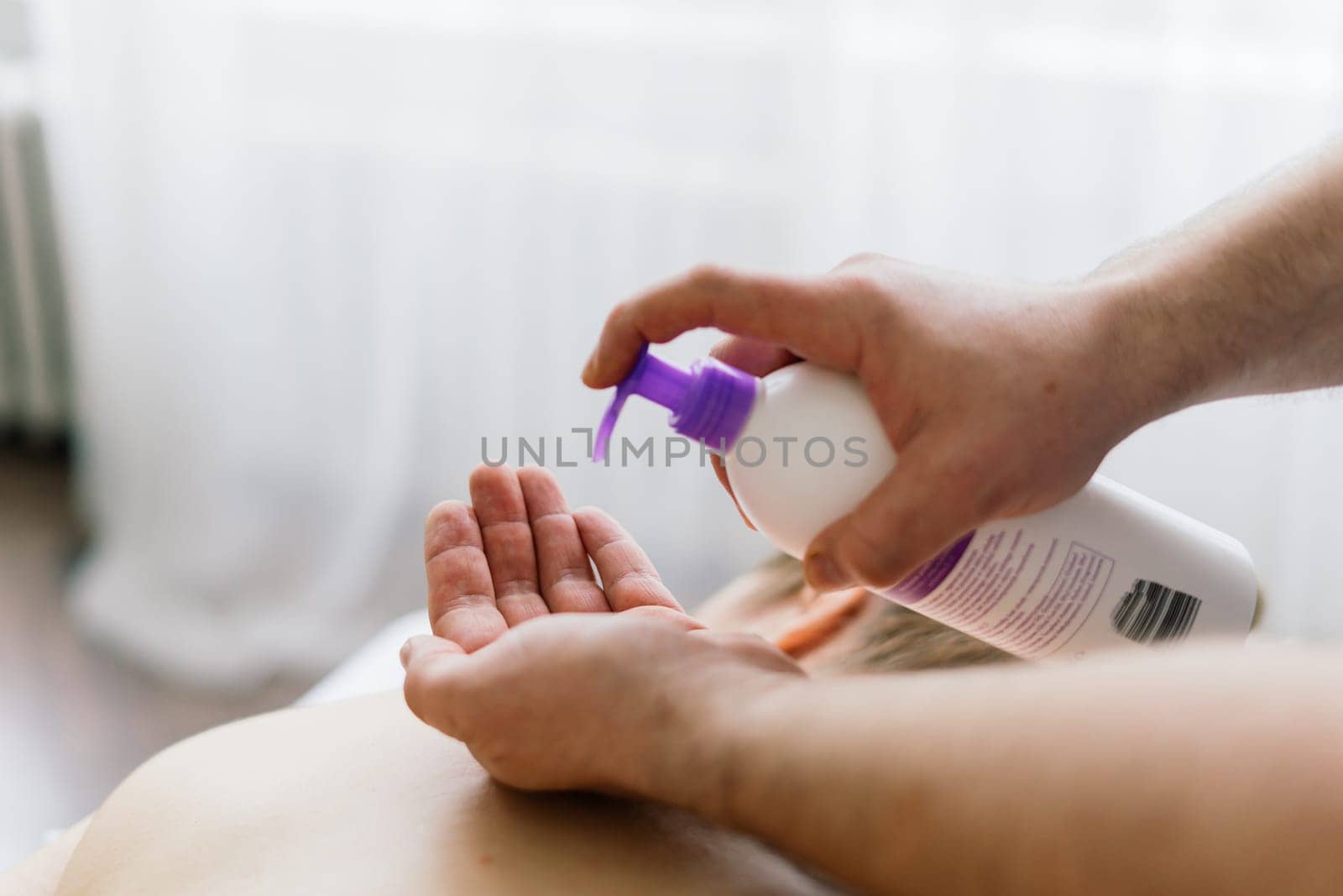 Plump woman getting hot stones arm massage in spa salon. Therapy, wellness and relaxation concept by Zelenin