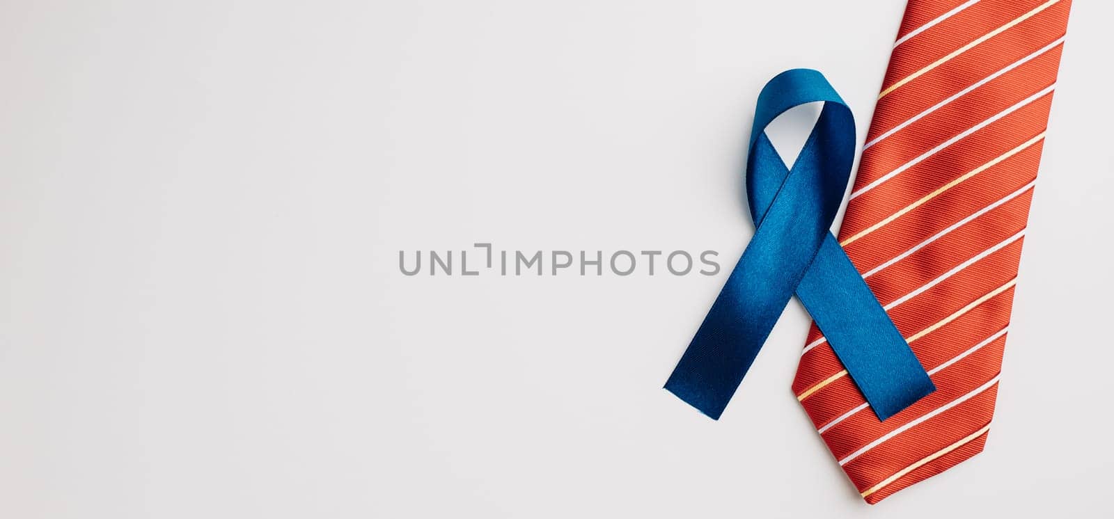 In November and September, a blue ribbon takes the spotlight, symbolizing prostate cancer and men's health awareness on a white background.