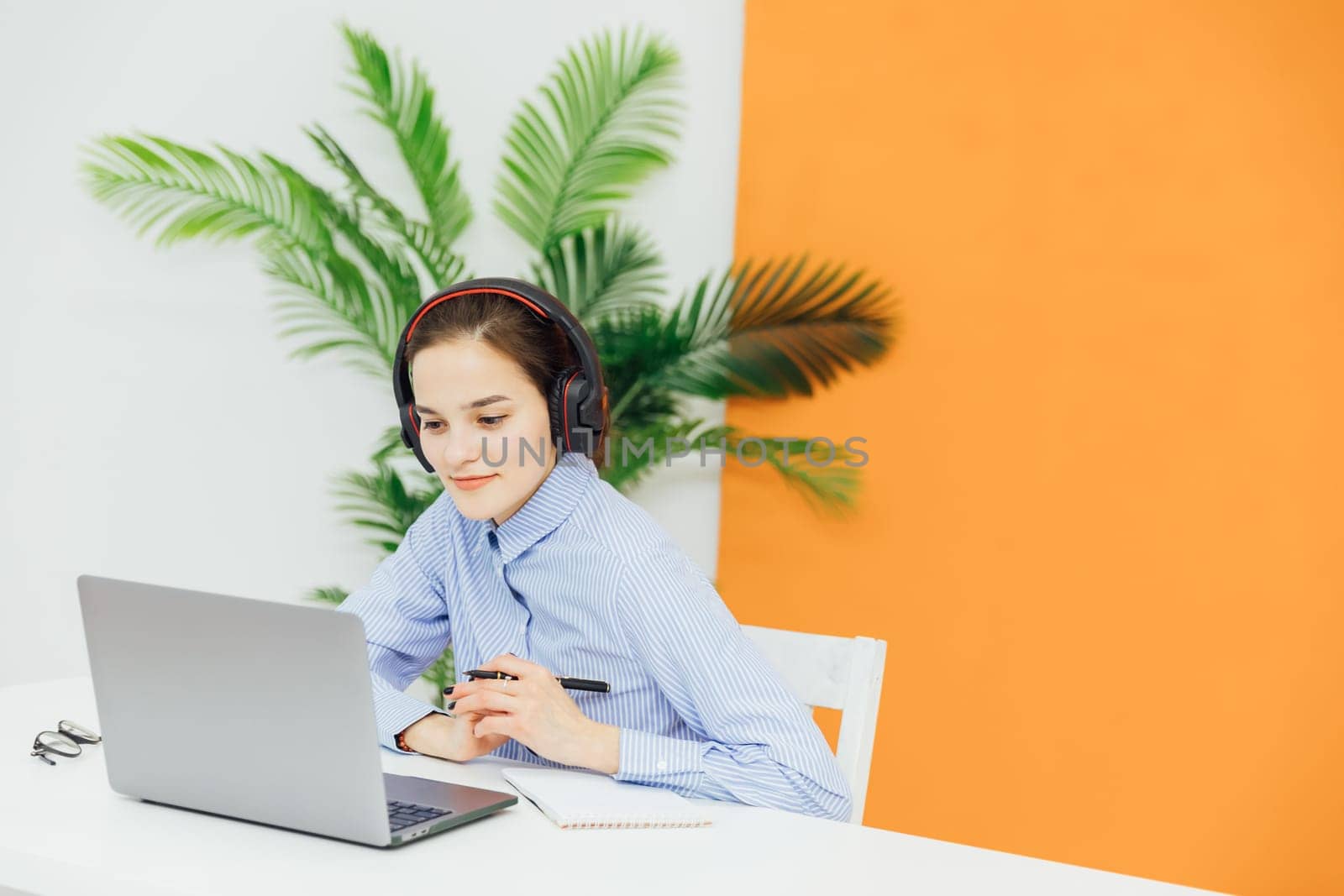 woman secretary in office working online on computer