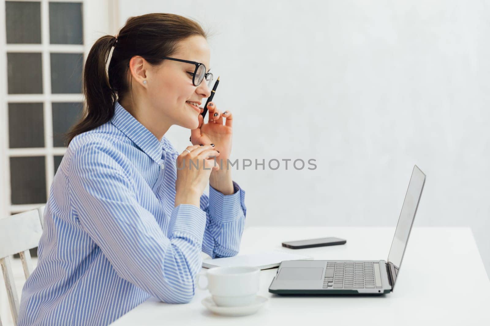 woman secretary in office working online on computer
