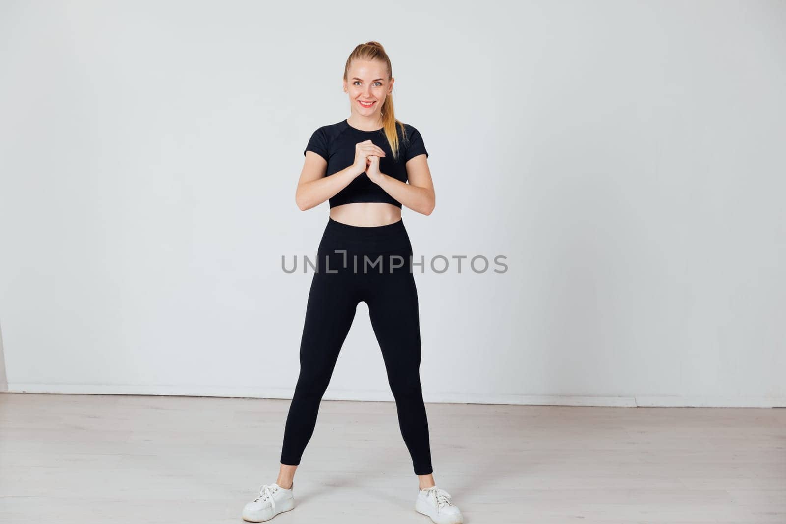 a woman in black tracksuit exercise sport in the gym warm-up exercises