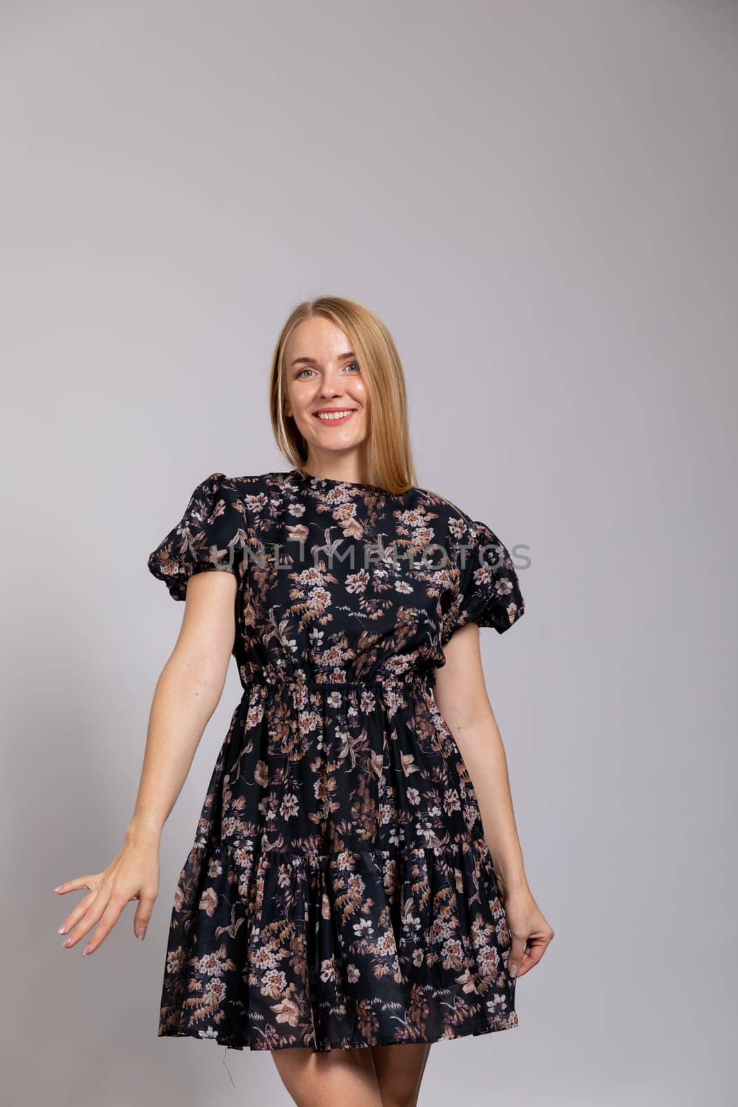 beautiful blonde in a dress on white background in the room