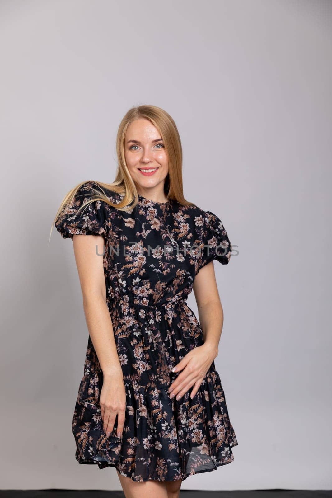 beautiful blonde in a dress on white background in the room