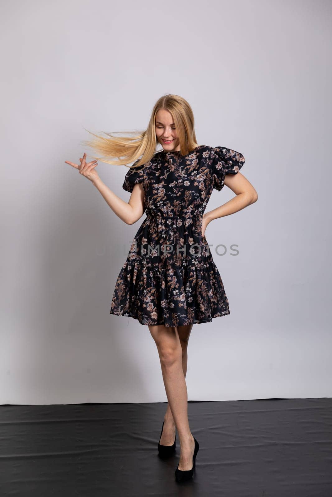 beautiful blonde dancing on white background