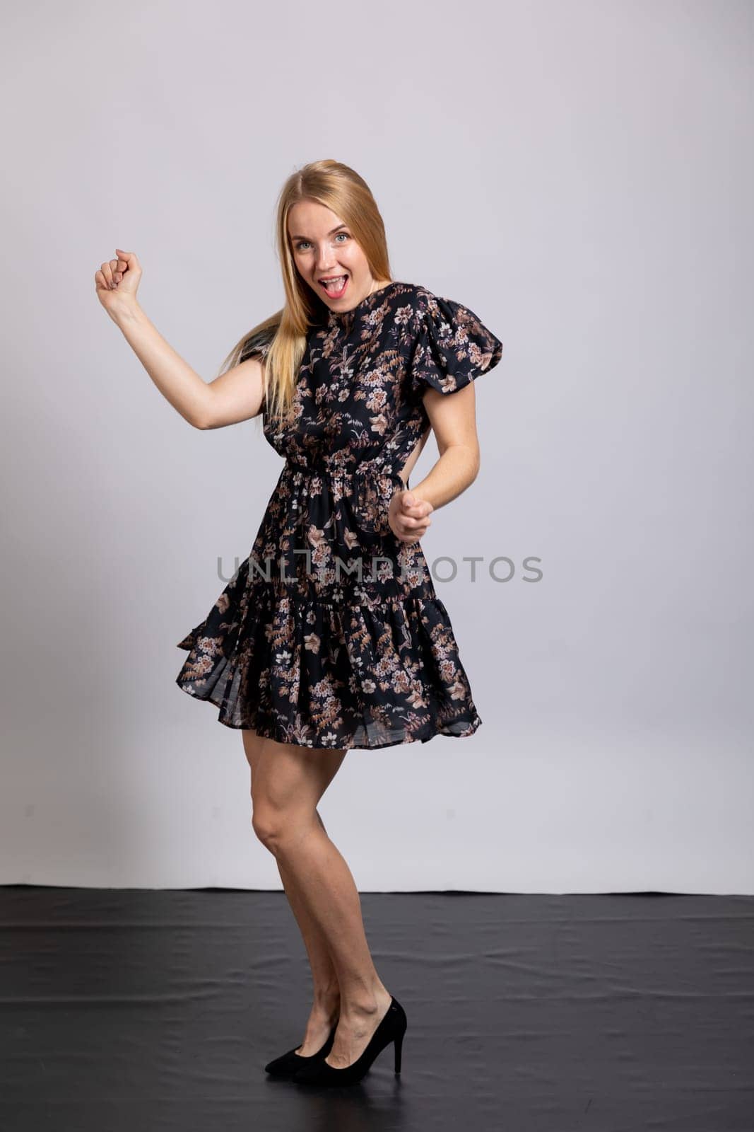 a beautiful blonde dancing on a white background