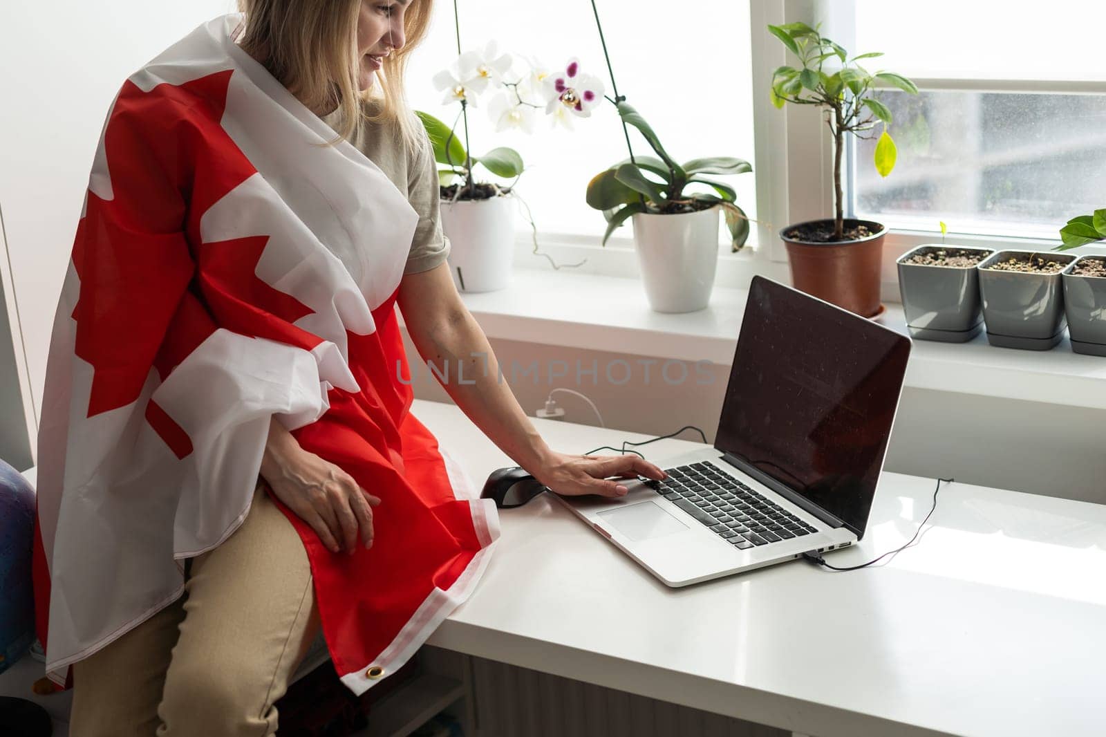 Beautiful young woman with flag of Canada . High quality photo