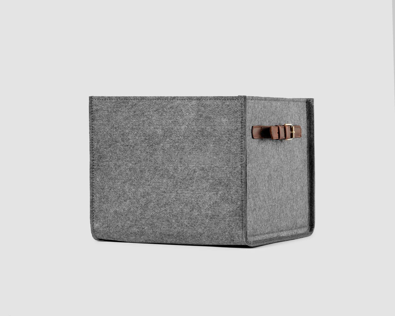 Compact practical box of gray felt with brown faux leather handles for convenient storage of clothes or books. Handmade interior items