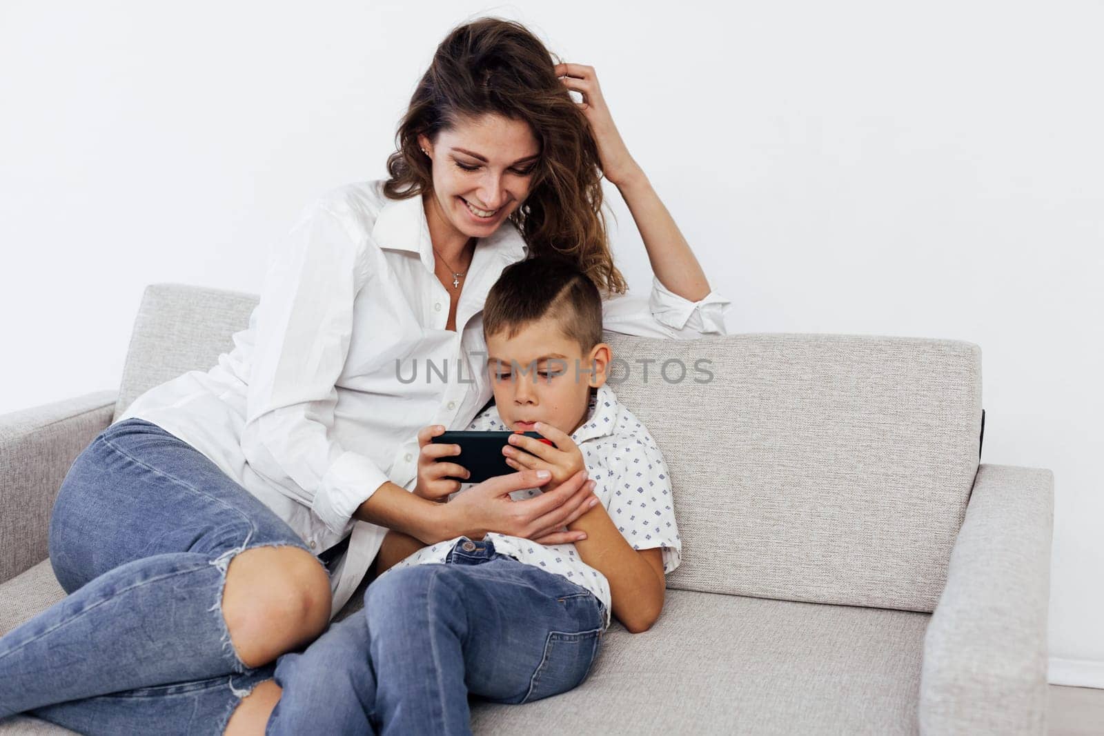 baby and mom plays in phone use internet on smartphone