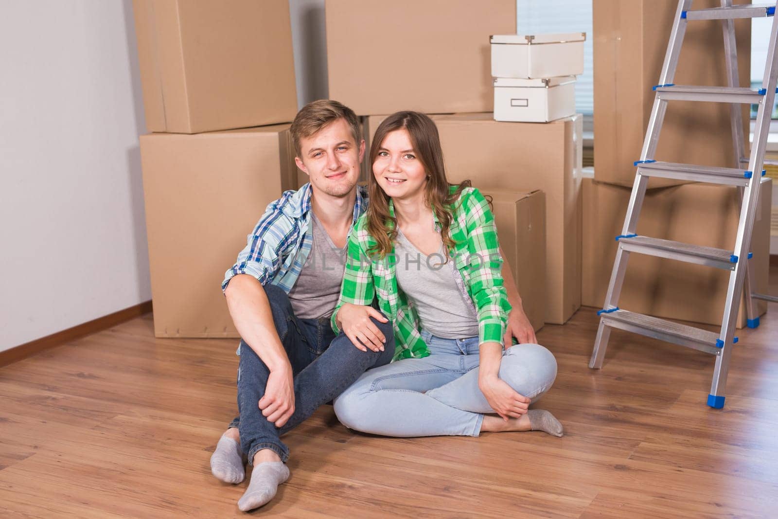 Home, people, moving and real estate concept - Portrait of happy couple in new home.
