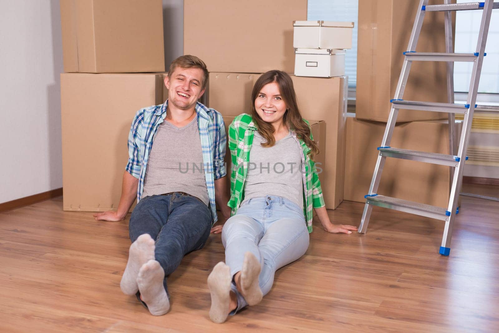 Home, people, moving and real estate concept - Portrait of happy couple in new home by Satura86