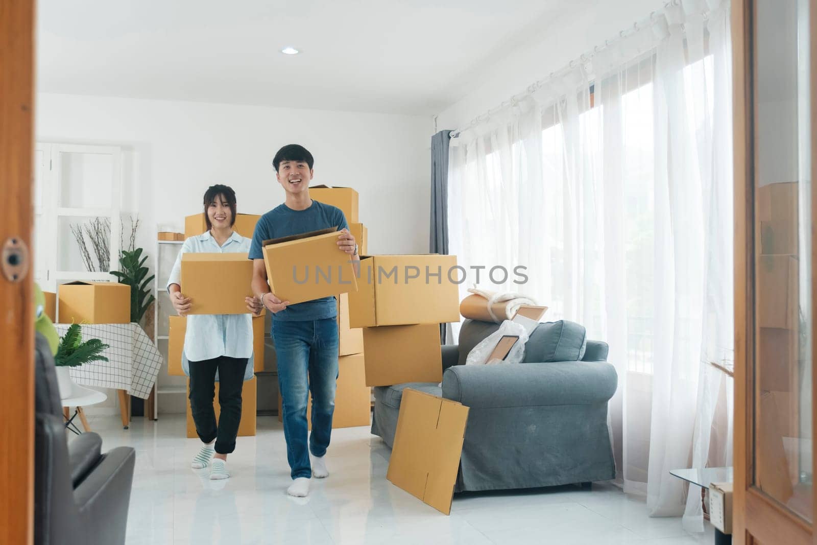 Asian young happy new married couple moving to their new house or real estate. by ijeab