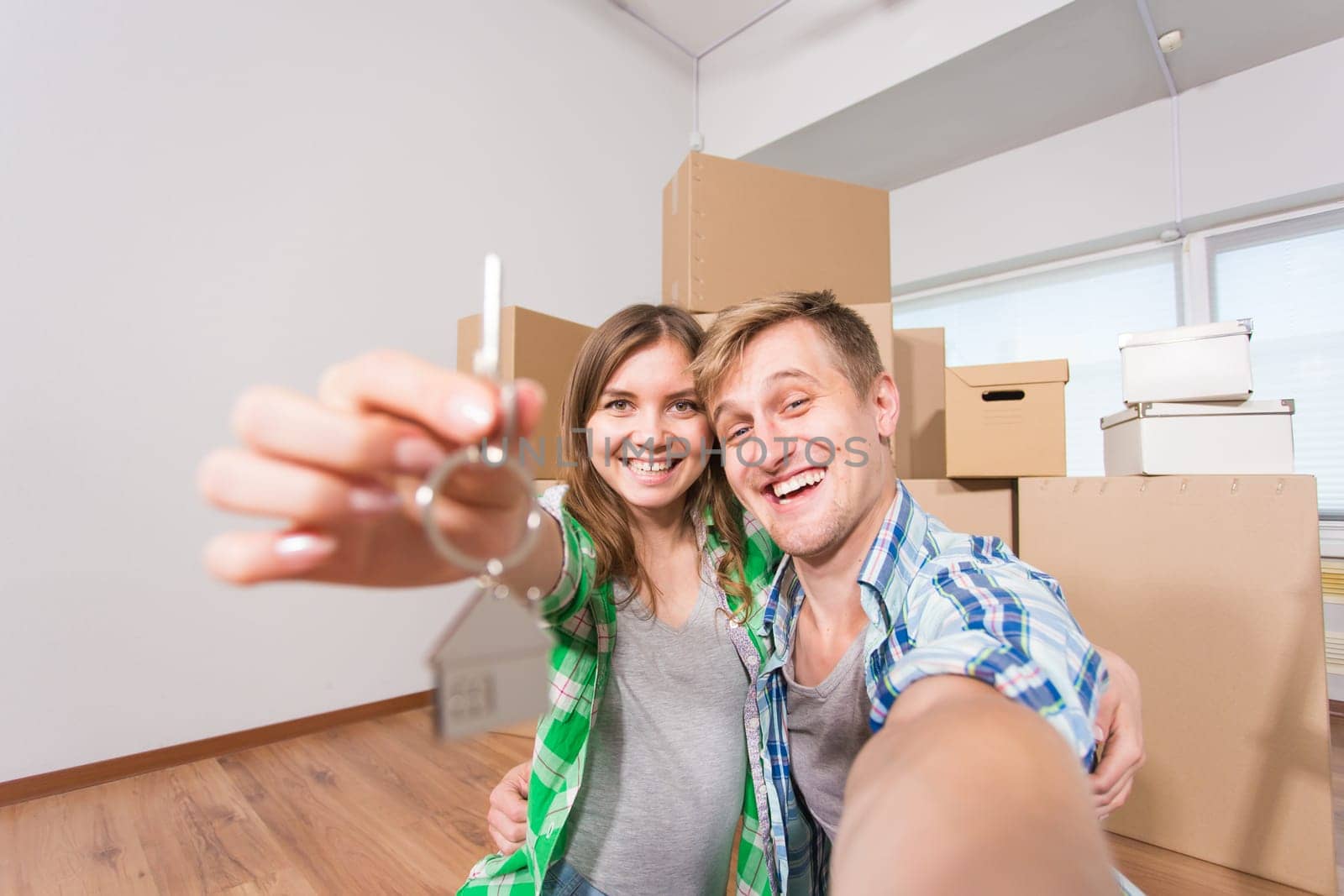 Young married funny couple with boxes and holding flat keys by Satura86