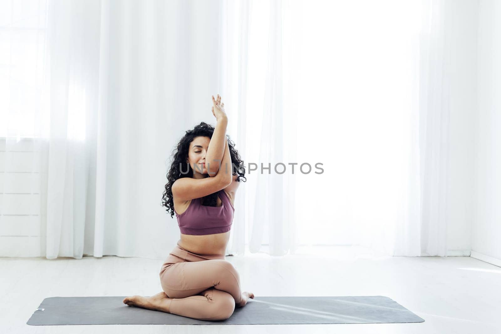 a woman doing yoga acrobat gymnast exercises for weight loss flexibility of the body