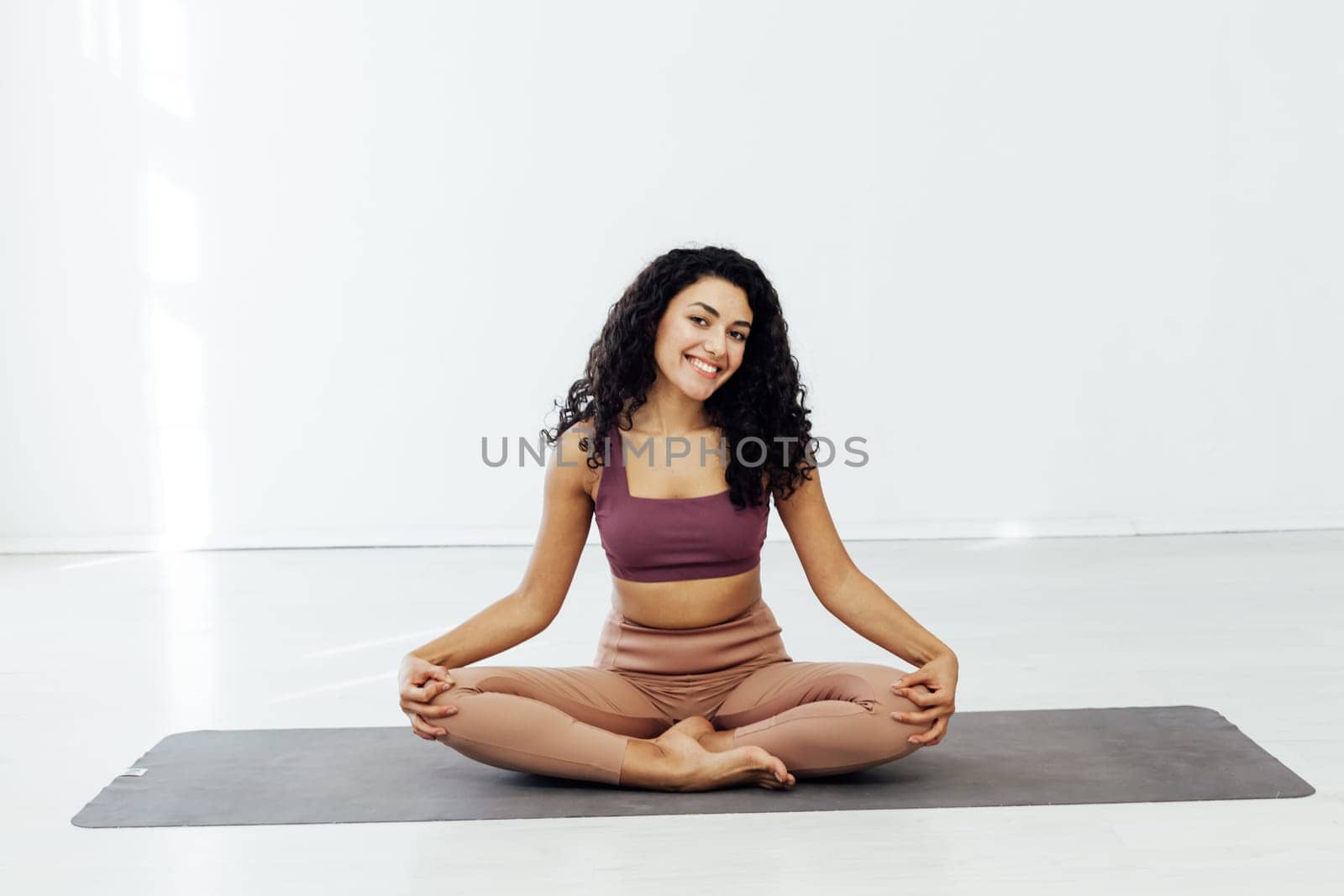 a woman on sports acrobatics yoga lotus pose gymnast