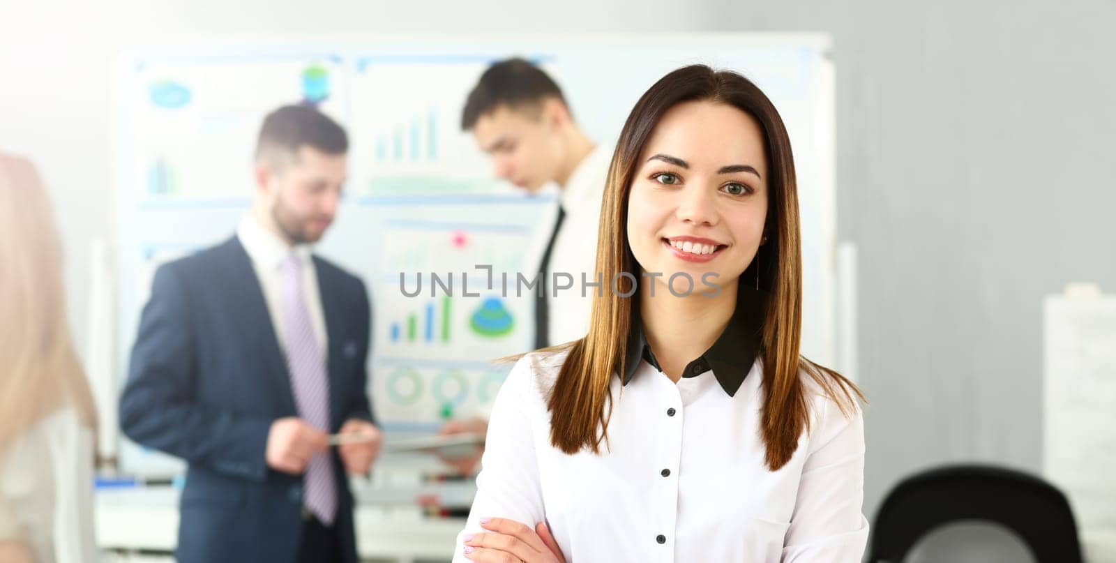 Portrait of beutiful female working on intense business project. Smart woman discussing questionable subject with witty colleagues. Company meeting concept