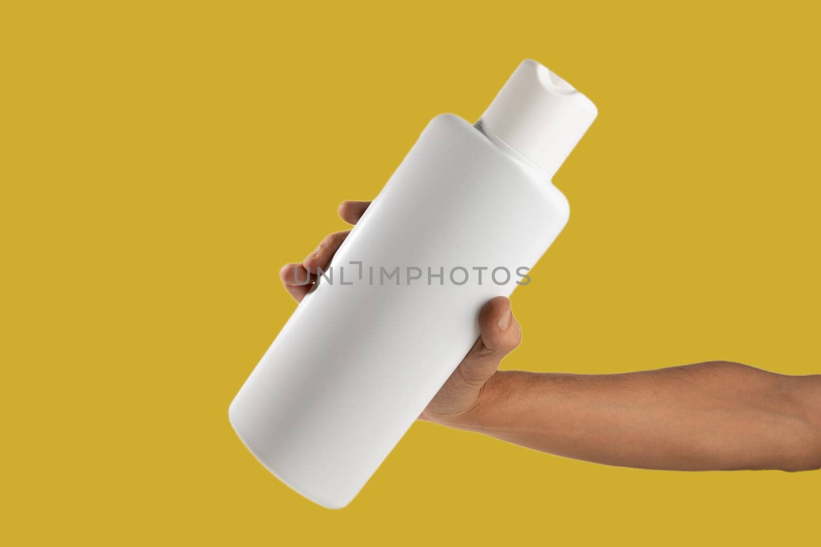 Mockup of unbranded white shampoo or conditioner bottle on yellow background by TropicalNinjaStudio