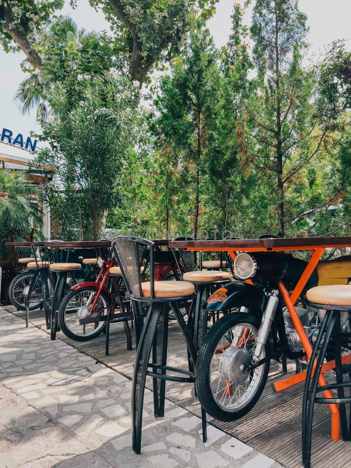 Tables in a street cafe on retro motorcycles. High quality photo
