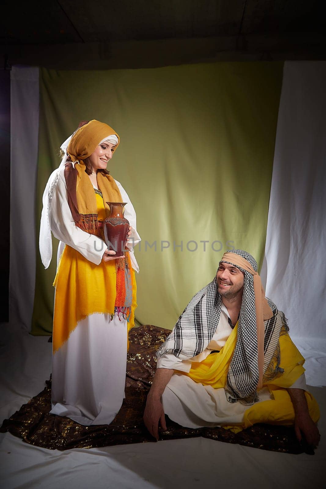 A couple in love or a married couple in stylized Eastern clothing from Israel, Palestine, Iran, Pakistan together. Tender photo session in the style of the Middle East and the Bible