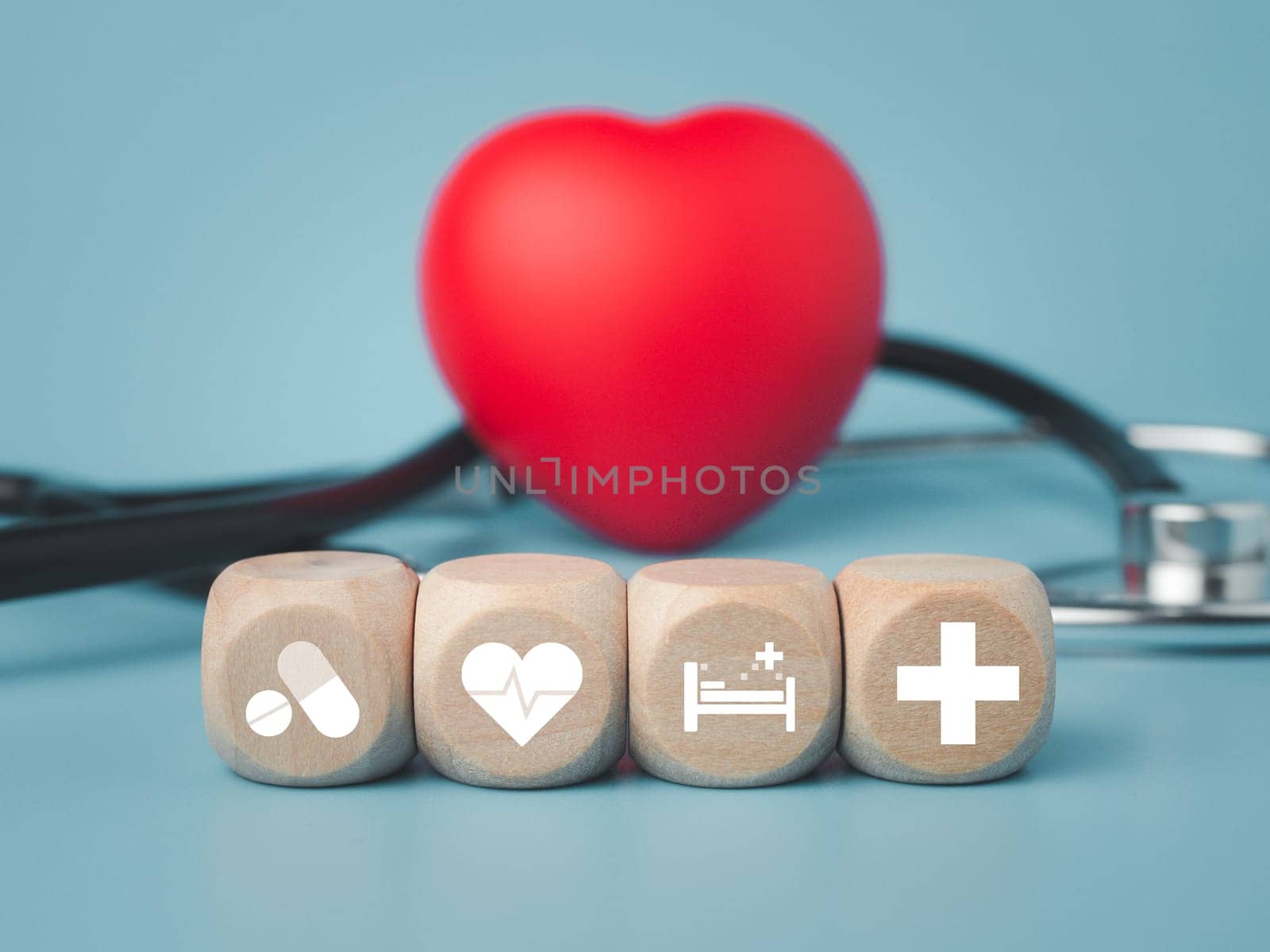 The concept of health insurance and medical welfare. Block wooden and red heart with plus icon. Health insurance and access to health care.  by Unimages2527